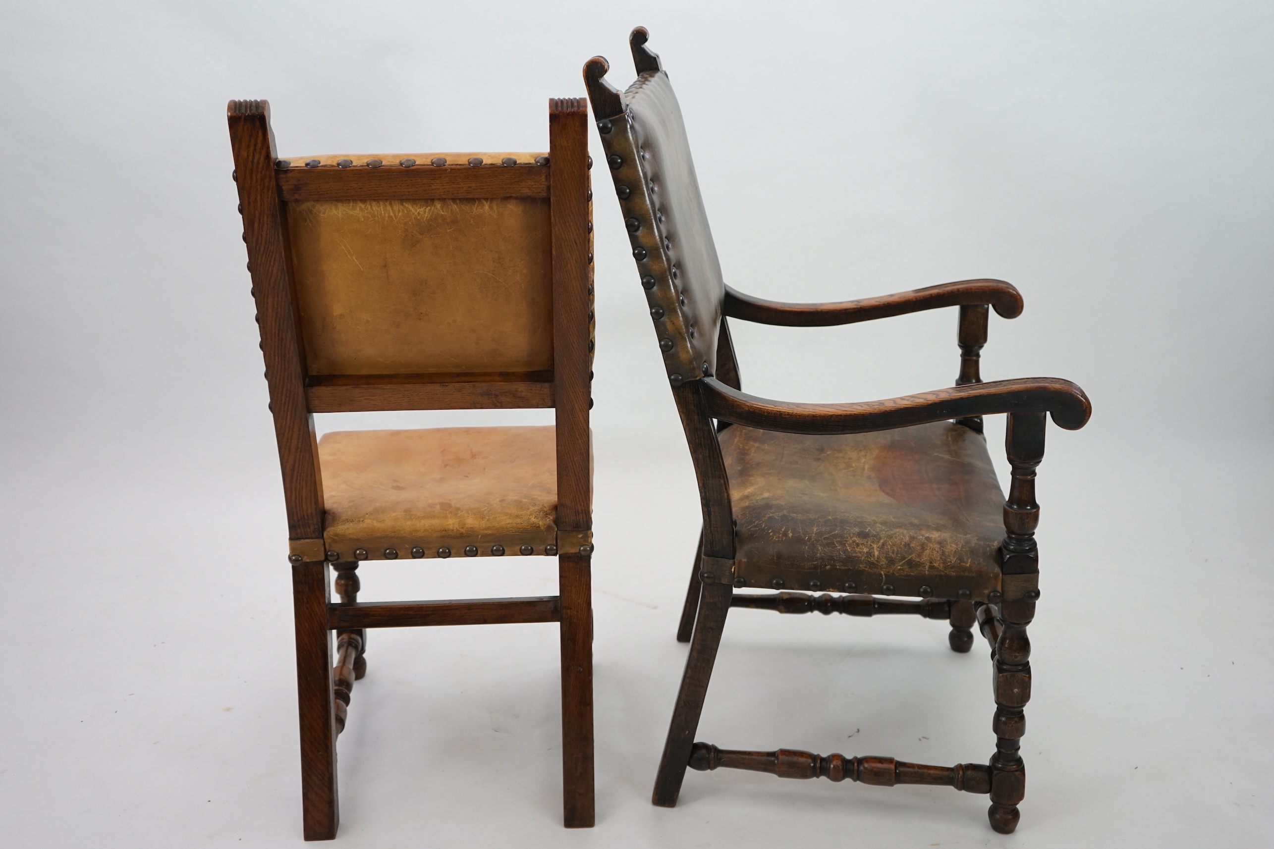 A set of fourteen 17th century style oak dining chairs including a pair of carvers